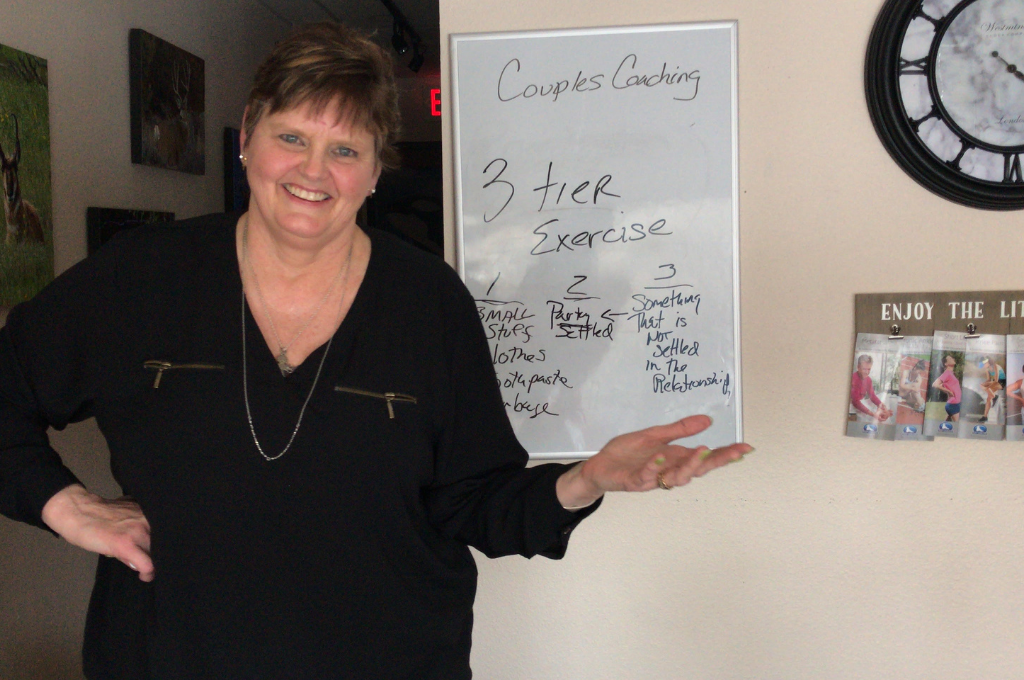 Laura Pollard in front of white board showing the three tier exercise